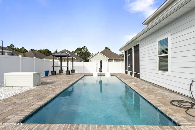 view of pool featuring a fenced in pool, a patio, a sunroom, a fenced backyard, and a gazebo