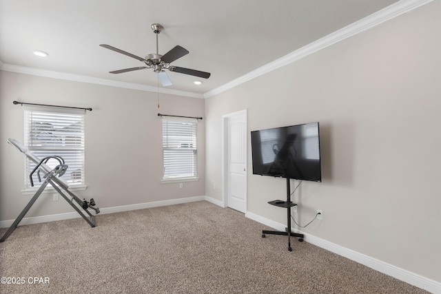 exercise room featuring ornamental molding, carpet, baseboards, and a ceiling fan