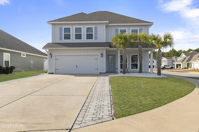 view of front facade featuring driveway, a shingled roof, an attached garage, board and batten siding, and a front yard