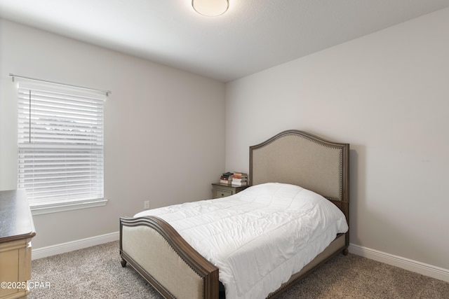 bedroom featuring light colored carpet, baseboards, and multiple windows