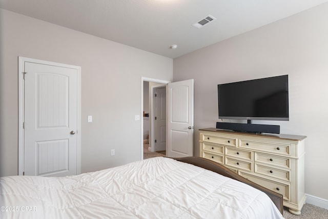 bedroom featuring baseboards, visible vents, and light colored carpet