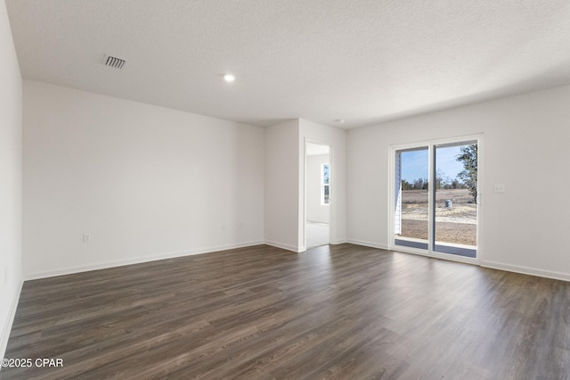 unfurnished room with dark hardwood / wood-style floors and a textured ceiling