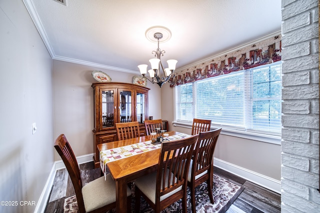 dining space featuring ornamental molding, dark hardwood / wood-style floors, and a notable chandelier