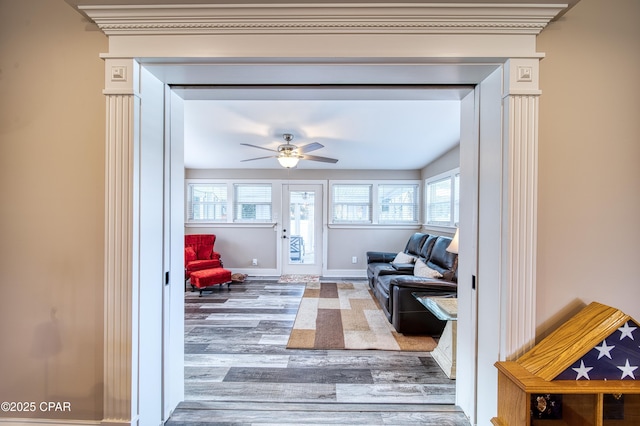 living room with wood-type flooring and ceiling fan