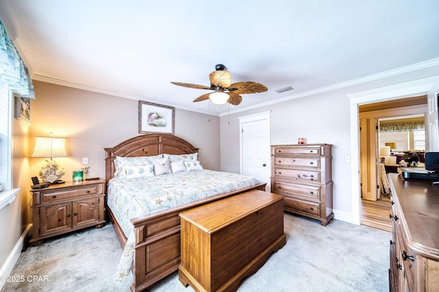 bedroom with crown molding, light carpet, ceiling fan, and a closet