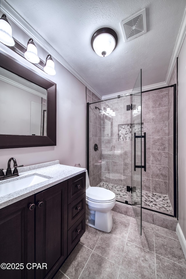 bathroom with vanity, ornamental molding, a textured ceiling, toilet, and walk in shower