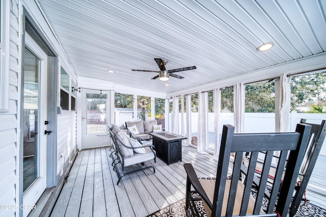 sunroom featuring ceiling fan