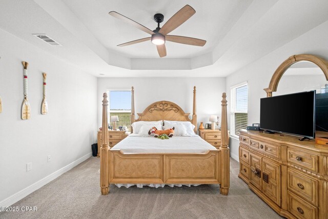 4701 Maegans Ridge Rd, Panama City, FL 32404 - bedroom featuring ceiling fan, visible vents, baseboards, light carpet, and a tray ceiling
