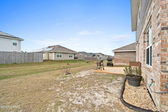 4701 Maegans Ridge Rd, Panama City, FL 32404 - rear view of property featuring brick siding, roof mounted solar panels, central AC unit, a lawn, and a patio