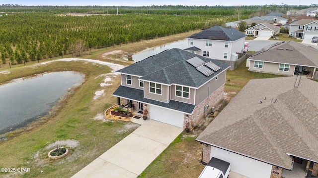 4701 Maegans Ridge Rd, Panama City, FL 32404 - view of front of home featuring a front lawn, brick siding, a shingled roof, an attached garage, and driveway