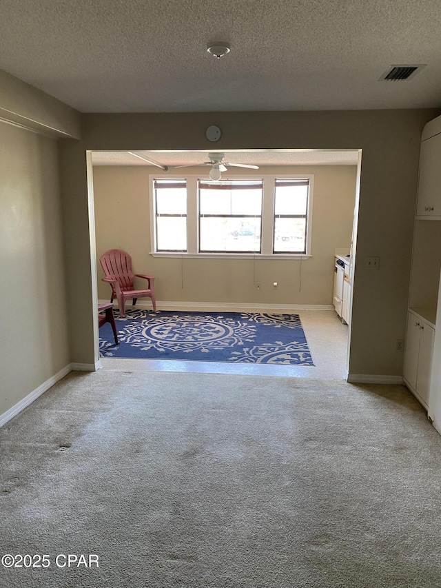8730 Thomas Dr Unit 1209C, Panama City Beach, FL 32408 - unfurnished room with a textured ceiling, light carpet, ceiling fan, and baseboards