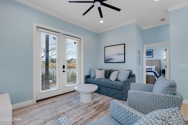 living room featuring ornamental molding, ceiling fan, french doors, and baseboards