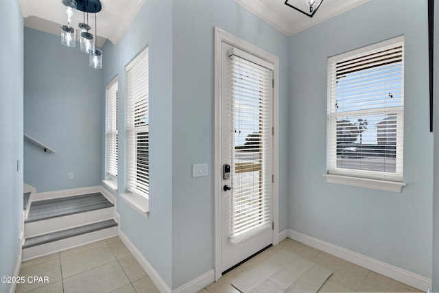 doorway featuring light tile patterned floors, a healthy amount of sunlight, baseboards, and crown molding