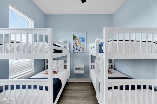 bedroom featuring dark wood-style floors, baseboards, and a ceiling fan