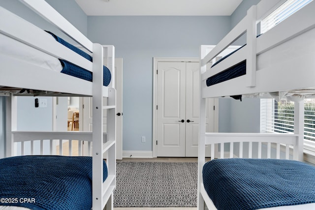 bedroom with baseboards and a closet