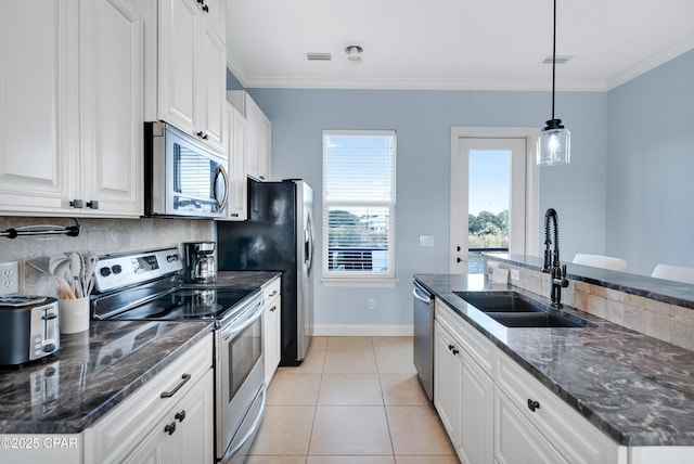 kitchen with decorative light fixtures, visible vents, appliances with stainless steel finishes, white cabinetry, and a sink