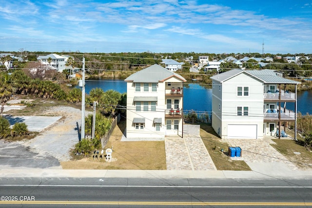 drone / aerial view with a water view and a residential view