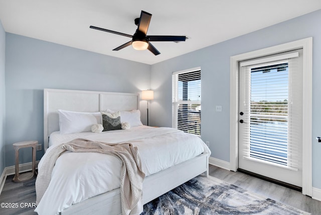 bedroom featuring access to exterior, ceiling fan, baseboards, and wood finished floors