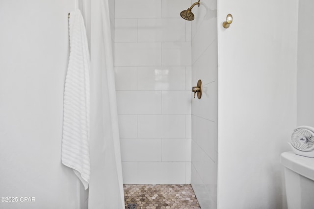 bathroom featuring toilet and a shower with shower curtain