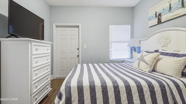 bedroom with dark hardwood / wood-style flooring