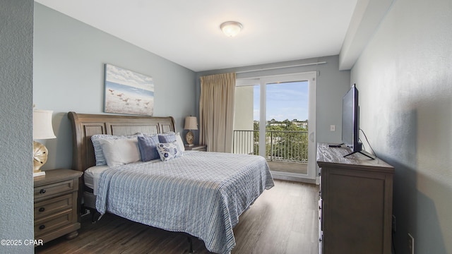 bedroom with dark wood-type flooring and access to outside