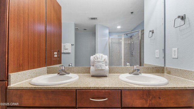 bathroom featuring vanity and a shower with door