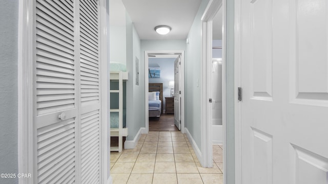 hall featuring light tile patterned floors