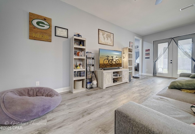living room featuring light hardwood / wood-style floors and french doors