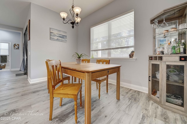 dining area with a chandelier and light wood-type flooring