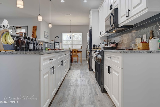 kitchen featuring white cabinetry, an inviting chandelier, decorative light fixtures, decorative backsplash, and black appliances