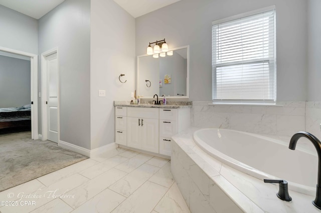 bathroom with vanity and tiled tub