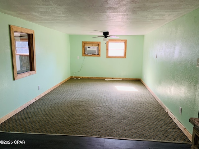 unfurnished room featuring ceiling fan, a textured ceiling, baseboards, and carpet flooring