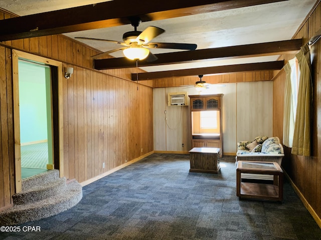 unfurnished room with dark colored carpet, wood walls, and beamed ceiling