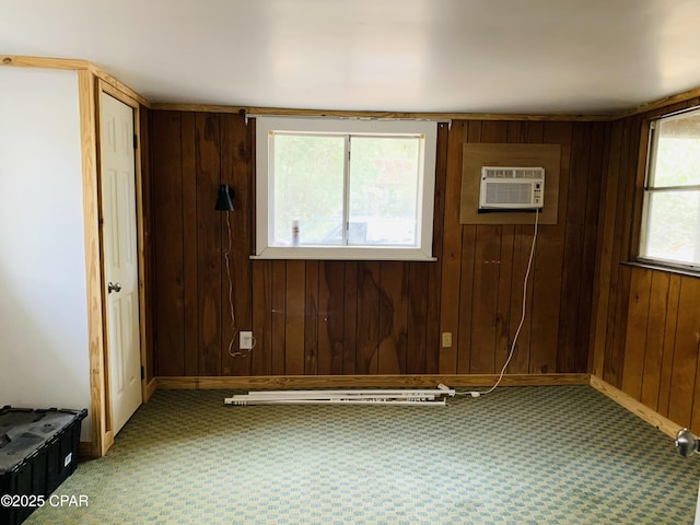 empty room with baseboards, a wall mounted air conditioner, and wooden walls