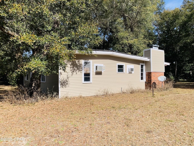 view of property exterior with a yard