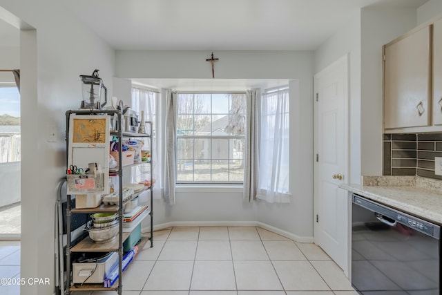 dining area featuring light tile patterned flooring and baseboards