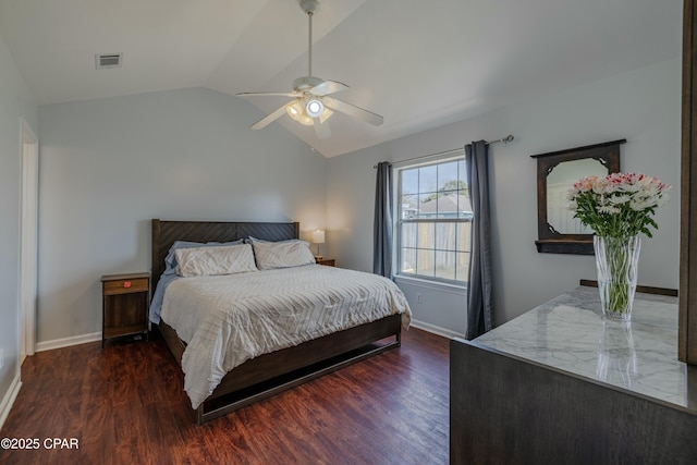 bedroom with vaulted ceiling, wood finished floors, baseboards, and visible vents