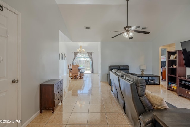 living room featuring light tile patterned floors, visible vents, ceiling fan with notable chandelier, and vaulted ceiling