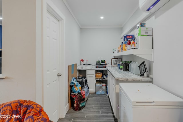 laundry area with wood tiled floor, a wall mounted air conditioner, ornamental molding, laundry area, and recessed lighting