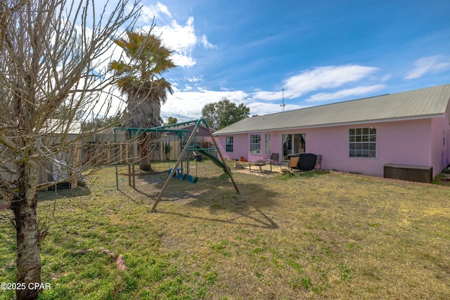 exterior space with fence and a playground