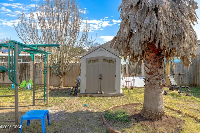 view of shed featuring fence and a playground