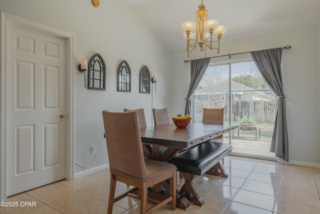 dining room featuring lofted ceiling, light tile patterned floors, baseboards, and a chandelier