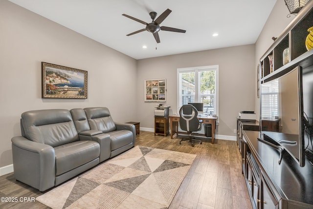 office featuring a ceiling fan, recessed lighting, light wood-style flooring, and baseboards