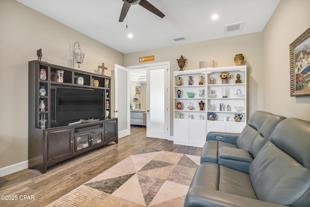 living area featuring baseboards, visible vents, ceiling fan, wood finished floors, and recessed lighting