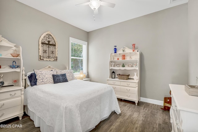 bedroom with a ceiling fan, dark wood-style flooring, and baseboards