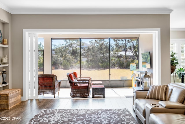 living room with hardwood / wood-style flooring and crown molding