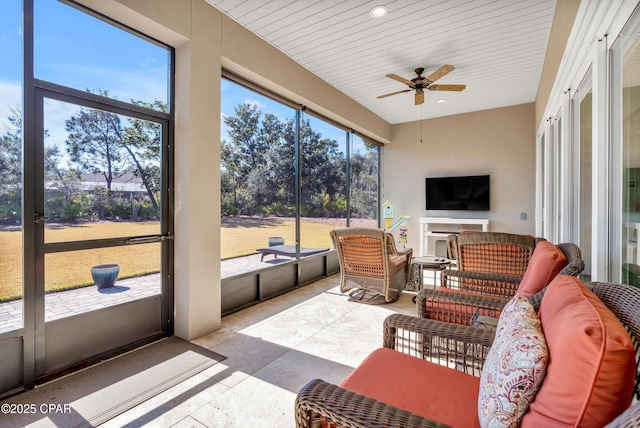 sunroom featuring a wealth of natural light and a ceiling fan