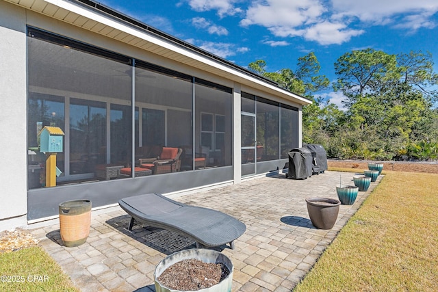 view of patio / terrace featuring a sunroom and area for grilling