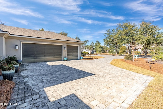 garage featuring decorative driveway