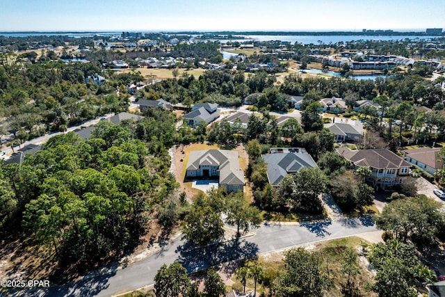 drone / aerial view featuring a water view and a residential view